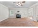 Bright living room with fireplace, ceiling fan, and access to the backyard at 162 Aylesbury Blvd, Mcdonough, GA 30252
