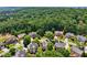 Aerial view of a community with mature trees, green lawns, and well-maintained homes, offering a serene setting at 5511 Highland Preserve Dr, Mableton, GA 30126