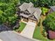 Aerial view of the house with landscaped front yard, two-car garage, and well-maintained lawn at 5511 Highland Preserve Dr, Mableton, GA 30126