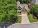 Aerial view of the two-story house showing the large manicured lawn, long driveway and beautiful landscaping at 5511 Highland Preserve Dr, Mableton, GA 30126