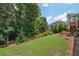 Well-maintained lawn and lush greenery offer a serene backdrop for the home with a wooden deck at 5511 Highland Preserve Dr, Mableton, GA 30126
