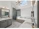 This relaxing bathroom features double sinks, a large jacuzzi tub, and a stylish, tiled shower behind glass at 5511 Highland Preserve Dr, Mableton, GA 30126