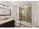 Well-lit bathroom featuring a glass shower, dark vanity, and decorative mirror at 5511 Highland Preserve Dr, Mableton, GA 30126