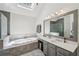 Elegant bathroom with double sinks, jacuzzi tub with tile surround, and a tiled shower with a glass enclosure at 5511 Highland Preserve Dr, Mableton, GA 30126