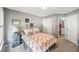 Comfortable bedroom with a patterned bedspread, carpet floors, and plenty of natural light from the backyard at 5511 Highland Preserve Dr, Mableton, GA 30126