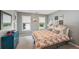 Cozy bedroom with colorful patterned bedding and bright turquoise dresser with natural light from two windows at 5511 Highland Preserve Dr, Mableton, GA 30126