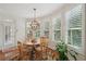 Cozy breakfast nook featuring a round table, bright windows with plantation shutters, and hardwood floors at 5511 Highland Preserve Dr, Mableton, GA 30126