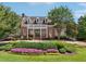 Clubhouse exterior with brick facade, white trim, and landscaped front yard with colorful flowers at 5511 Highland Preserve Dr, Mableton, GA 30126
