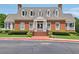 Exterior of brick clubhouse with white columns, manicured lawn, and accessible parking at 5511 Highland Preserve Dr, Mableton, GA 30126