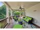 Comfortable covered patio with ceiling fan, wicker seating, and outdoor decor at 5511 Highland Preserve Dr, Mableton, GA 30126