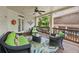 Charming covered patio with stylish wicker furniture, decor, and wooded views at 5511 Highland Preserve Dr, Mableton, GA 30126