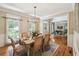 Elegant dining room featuring hardwood floors, wainscoting, and a stylish chandelier at 5511 Highland Preserve Dr, Mableton, GA 30126
