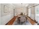 Elegant dining room with wood floors, wainscoting, and stylish light fixture at 5511 Highland Preserve Dr, Mableton, GA 30126