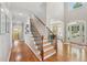 Bright foyer with gleaming hardwood floors, grand staircase, and arched entryway at 5511 Highland Preserve Dr, Mableton, GA 30126