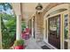 Cozy front porch with rocking chairs, brick flooring, and a welcoming entrance at 5511 Highland Preserve Dr, Mableton, GA 30126