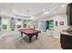Spacious game room boasts a pool table, bar area, and adjacent golf simulator for recreation at 5511 Highland Preserve Dr, Mableton, GA 30126