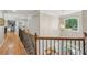 Upstairs hallway with an office, wood flooring, and decorative lighting at 5511 Highland Preserve Dr, Mableton, GA 30126