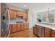 Bright kitchen with wooden cabinets, stainless steel appliances, and a large window with natural light at 5511 Highland Preserve Dr, Mableton, GA 30126