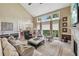 Open-concept living room with a fireplace and view into the kitchen at 5511 Highland Preserve Dr, Mableton, GA 30126