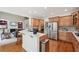 Open-concept kitchen featuring a breakfast bar, stainless steel appliances, and views of the living room at 5511 Highland Preserve Dr, Mableton, GA 30126