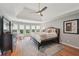 This beautiful main bedroom features a tray ceiling and a wall of windows bringing in lots of natural light at 5511 Highland Preserve Dr, Mableton, GA 30126