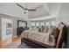 Sun-filled main bedroom boasts a tray ceiling, hardwood floors, and a stylish dresser with a decorative mirror at 5511 Highland Preserve Dr, Mableton, GA 30126