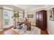 Bright office with large windows, a wooden desk, and a statement floor lamp at 5511 Highland Preserve Dr, Mableton, GA 30126