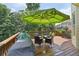 Outdoor patio with grill and covered seating area surrounded by trees at 5511 Highland Preserve Dr, Mableton, GA 30126