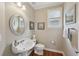 Charming powder room with a pedestal sink, hardwood floors, and elegant decor at 5511 Highland Preserve Dr, Mableton, GA 30126