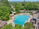 Aerial image of the community pool featuring a slide, wading pool, and lounge seating surrounded by trees at 5511 Highland Preserve Dr, Mableton, GA 30126