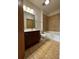 Bathroom features a vanity, tile flooring, tub, and tiled shower, providing a functional space at 898 Oak St Sw # 1311, Atlanta, GA 30310