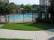 Community swimming pool is fenced with grass and concrete sidewalks at 898 Oak St Sw # 1311, Atlanta, GA 30310
