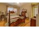 Bedroom with hardwood floors, a ceiling fan, a large bed, bedside tables, and a dresser at 1349 Springwood Nw Dr, Conyers, GA 30012