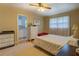 Cozy bedroom showcasing hardwood floors, a bright window, and neutral decor at 1349 Springwood Nw Dr, Conyers, GA 30012