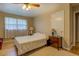 Inviting bedroom featuring hardwood floors, a bright window, and neutral decor at 1349 Springwood Nw Dr, Conyers, GA 30012