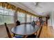 Sunlit dining area with hardwood floors, multiple windows, and comfortable seating at 1349 Springwood Nw Dr, Conyers, GA 30012