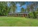 Charming brick home with a well-manicured lawn and mature trees offering great curb appeal at 1349 Springwood Nw Dr, Conyers, GA 30012
