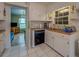 Functional kitchen with white cabinetry, blue tile counters, and an adjacent living space at 1349 Springwood Nw Dr, Conyers, GA 30012