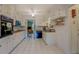Spacious kitchen features tiled floor, white cabinets and view into living area at 1349 Springwood Nw Dr, Conyers, GA 30012
