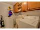 Practical laundry room with washer, dryer, sink, and storage cabinets at 1349 Springwood Nw Dr, Conyers, GA 30012
