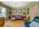 Cozy living room featuring a chandelier, area rug, window, and traditional-style furniture at 1349 Springwood Nw Dr, Conyers, GA 30012