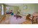 Cozy living room with hardwood floors, neutral paint, and an opening to another room at 1349 Springwood Nw Dr, Conyers, GA 30012