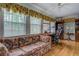 Bright sun room featuring large windows, comfortable seating, and a work space at 1349 Springwood Nw Dr, Conyers, GA 30012