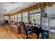 Bright sunroom featuring hardwood floors, floral valances, windows, and comfortable seating at 1349 Springwood Nw Dr, Conyers, GA 30012