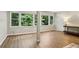 Finished basement featuring hardwood floors, a wall of windows with natural lighting, and neutral paint at 208 Hembree Park Ter, Roswell, GA 30076