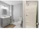 Bathroom features grey vanity, toilet, shower, and white hexagonal tile flooring at 208 Hembree Park Ter, Roswell, GA 30076