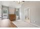 Neutral bedroom with vaulted ceiling and carpet, view into bathroom, modern furniture and large windows at 208 Hembree Park Ter, Roswell, GA 30076