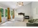 Bright bedroom with a ceiling fan, large windows, and an accent chair creates an inviting space at 208 Hembree Park Ter, Roswell, GA 30076