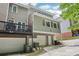 Rear view of the townhomes, including attached garages and wooden balconies at 208 Hembree Park Ter, Roswell, GA 30076