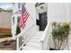 The home features a welcoming front entrance, a classic white-painted brick facade, and a manicured front yard at 208 Hembree Park Ter, Roswell, GA 30076